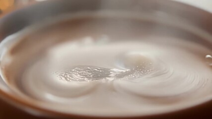 Poster - The steam from a cup of hot cocoa is captured in slow motion creating a dreamy and indulgent aesthetic.