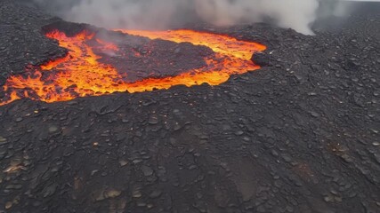 Aufkleber - The vibrant glowing orange of the molten lava fades into a dark ashen grey as it cools leaving behind a smooth and solid surface.