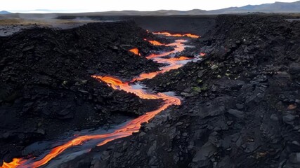 Aufkleber - A birds eye view of a river of lava snaking through a field of boulders leaving behind its fiery trail and creating new formations as it carves its way through.