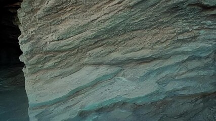 Aufkleber - A closeup of a small cave with exposed rock strata revealing the intricate patterns and shapes of the layered rocks formed by years of erosion.