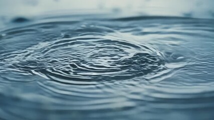 Aufkleber - Tiny raindrop ripples forming concentric circles in a puddle creating a hypnotic effect as each drop hits the waters surface.