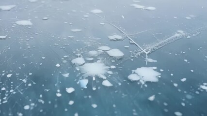 Aufkleber - A closeup of a frozen lake with delicate snowflakes resting on its surface and creating a unique texture.