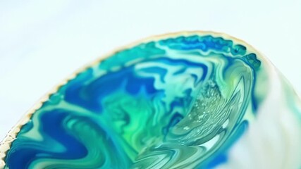 Poster - Intricate swirls and curving lines in shades of blue and green on a white sea shell resembling an underwater garden.