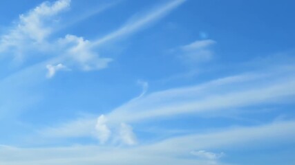 Aufkleber - Wispy delicate clouds gliding gracefully through a bright blue sky.