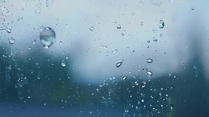 Aufkleber - A sequence of crystalclear water droplets forming on a window creating a magical and dreamy effect as they slide down the glass.