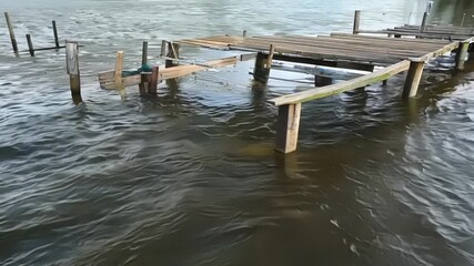 Aufkleber - A shot of a dock or pier being submerged as the river level rises showcasing the effects of changing water levels on humanmade structures.