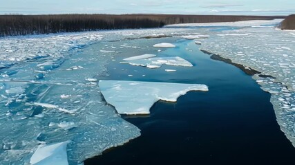 Poster - An aerial view of a river with chunks of ice breaking off the shoreline and melting as they float downstream.