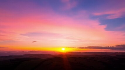Poster - The sun starts to dip below the horizon filling the sky with a stunning array of pinks purples and oranges signaling the end of another day.