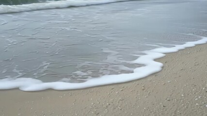 Aufkleber - The graceful movement of the waves as they weave in and out creating an everevolving display of intricate ripples and dips in the sand.