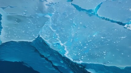 Aufkleber - A closeup of the deep blue cracks and crevices covering the surface of an iceberg revealing the intricate beauty of its melting process.