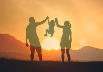 silhouette of family playing in the sunset 