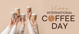 Female hands holding takeaway cups on beige background