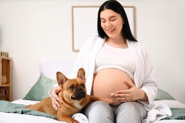 Wall Mural - Young pregnant woman with French bulldog in bedroom