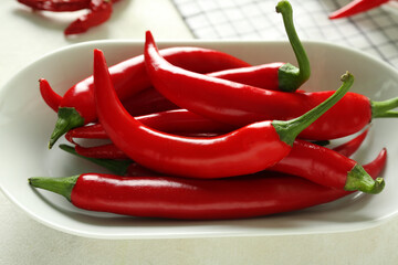 Poster - Plate of fresh chili peppers on light background