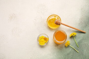 Wall Mural - Jar and bowls with dandelion honey on white background