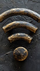 Retro styled golden metallic Wi-Fi symbol isolated on the black concrete wall background. The concept of wireless internet connection and modern telecommunication technologies.