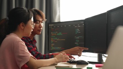 Slow motion back end software developer engineer for computer programming working together on debugging writing computing code, solving complex algorithms display on monitor in office. Burgeoning