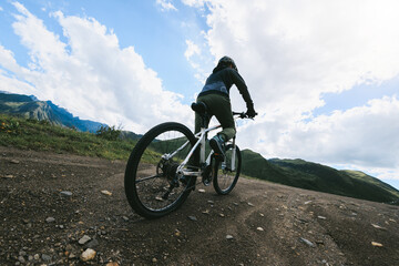 Wall Mural - Woman riding mountain bike in the beautiful mountains