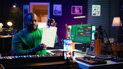 Leinwandbilder - Skilled performer explaining sheet with musical notes on online video tutorial, internet lessons in home studio. Producer artist teaching how to read acoustical notation, playing piano. Camera B.