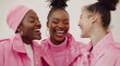 © yj - Three black women chatting and laughing happily together in in a studio environment. white backdrop with pink clothing. Girly, high-end look and feel. Editorial. Advertising. Emotive.
