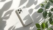 © Prime Stox - White phone case mockup on a plain white background with soft natural shadows