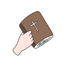 a hand holding a brown book with a cross on it