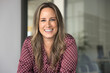 © fizkes - Cheerful attractive business leader woman in casual posing in office indoors, looking at camera with toothy smile, talking on online video conference call, smiling. Head shot portrait
