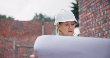 Wall Mural - Architect, woman and walking with blueprint at construction site, building design and inspection of expansion process. Female contractor, documents and infrastructure safety, project and development