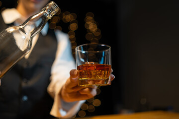 Wall Mural - Barwoman pouring whiskey whiskey glass..