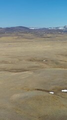 Wall Mural - Vertical aerial video of Kurai valley. In the background is the Kurai mountain range in Altai.