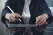 © tippapatt - Close up of business woman using stylus pen signing business contract on digital tablet via mobile app, e-signing, electronic signature concept. Businesswoman proofing e-document at office
