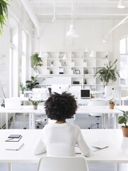 Poster - A high-resolution photo of a young entrepreneur working in a stylish, clean office space, soft natural light,