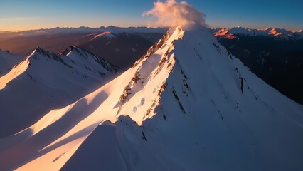 a cloud filled mountain as the sun sets in the distance from atop a mountain