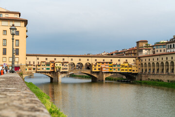 Wall Mural - Florence, Italy. Ponte Vecchio - Medieval arched bridge with souvenir and jewelry shops. Summer day