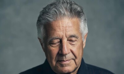 Poster - Portrait of a senior man with grey hairIsolated on grey background.