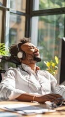 Poster - A man wearing headphones is sitting at a desk with a computer monitor
