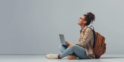 Poster - In a contemporary setting, a young lady in laidback clothing is outside, equipped with a laptop and a backpack, symbolizing todays lifestyle of students freelancers in the digital era