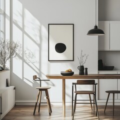 A white kitchen with a black and white framed picture on the wall. The kitchen has a wooden table with a bowl of fruit on it. There are two chairs around the table