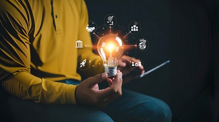 Business goals and target success concepts. Businessman holding a light bulb with business icons. business growth, Achievement company, corporate startup, investment goal, Planning ideas and strategy.