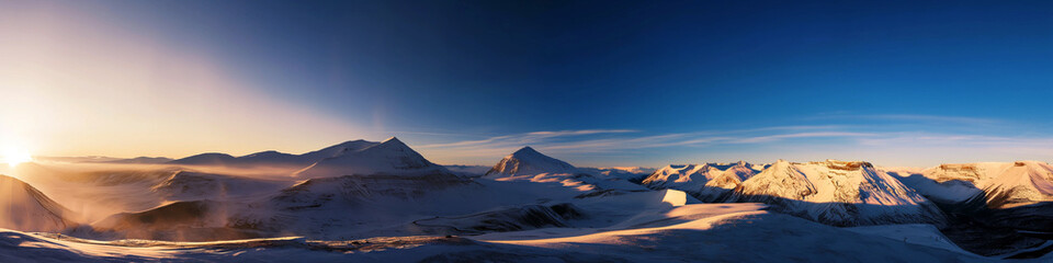 Wall Mural - a panoramic view of a snowy mountain range with a sun setting in the background