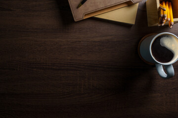 Wall Mural - Top view of working desk with notebook, pen, potted plant and coffee cup. Copy space for your text.