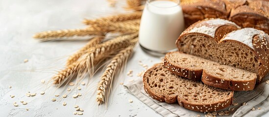 Sticker - Healthy food concept with a glass of milk and whole wheat bread on white background for text placement in copy space image