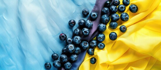 Poster - Top view macro image of bilberries on yellow and light blue kitchen textiles with copy space image