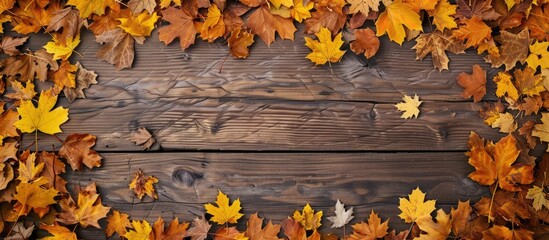 Aufkleber - Top down view of a vintage wooden table with a border of autumn leaves in yellow and orange hues creating a frame with room for text in the image. Creative banner. Copyspace image