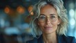 © AS Photo Family - Confident mature businesswoman in office setting with stylish glasses and professional attire