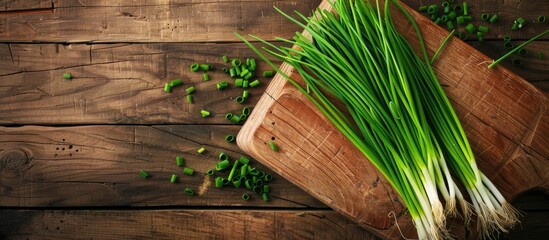 Aufkleber - Fresh spring chives on a wooden board with ample copy space image
