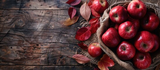 Poster - Table with red apples on rustic background with copy space image