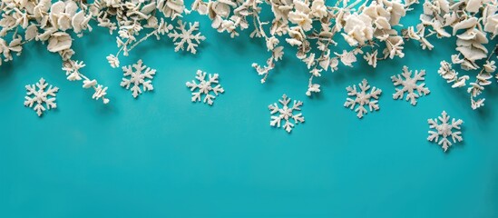 Sticker - Festive snowflakes decorations set against a vibrant turquoise backdrop with copy space image