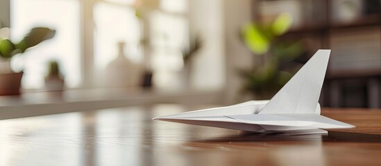 Poster - Paper airplane on desk with copy space image in the background