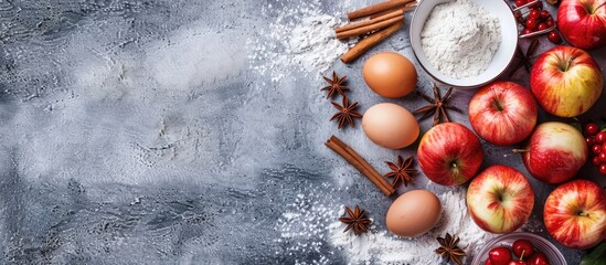 Poster - Top view of fresh apples cinnamon flour sugar and eggs on a stone background a copy space image depicting the concept of baking apple pie